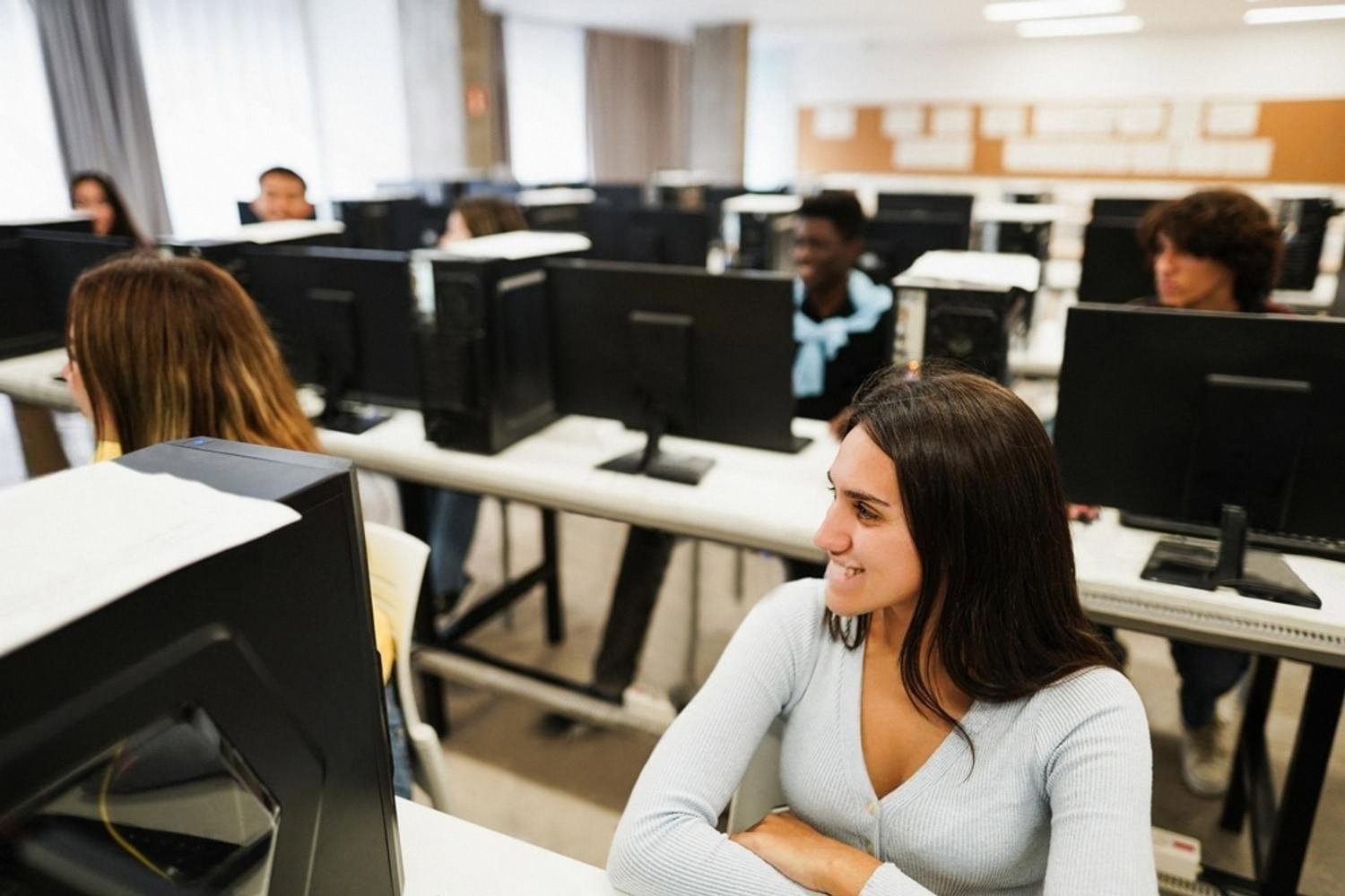 Young woman working in a computer lab during a BTEC IT class in the UAE