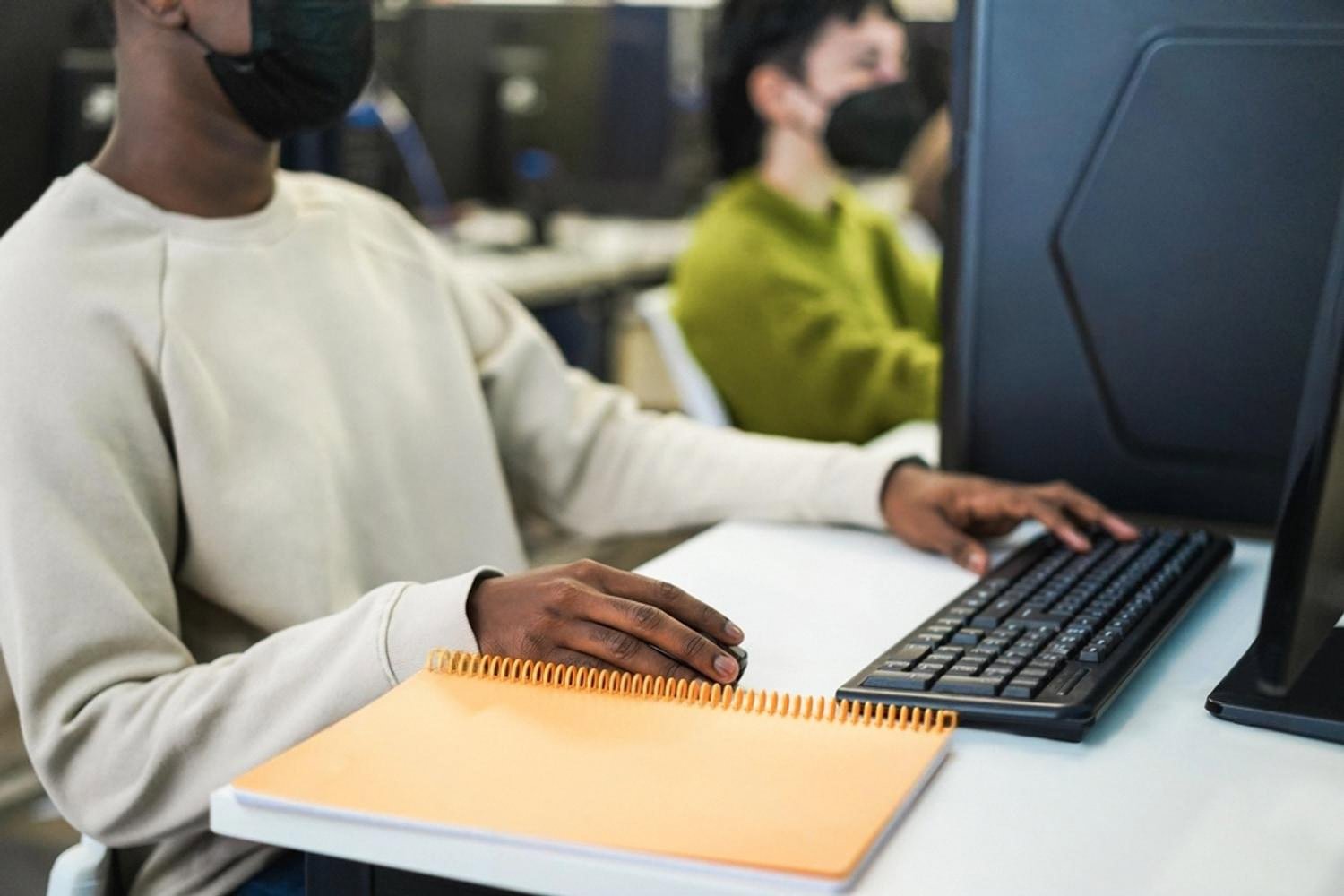 Student practising hands-on computer skills as part of a BTEC vocational course